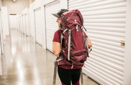 Girl with a backpack in front of indoor storage units at StorQuest Self Storage in Santa Monica, California