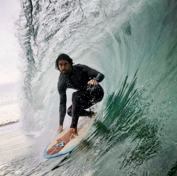 Dr. Cliff Kapono surfing a wave