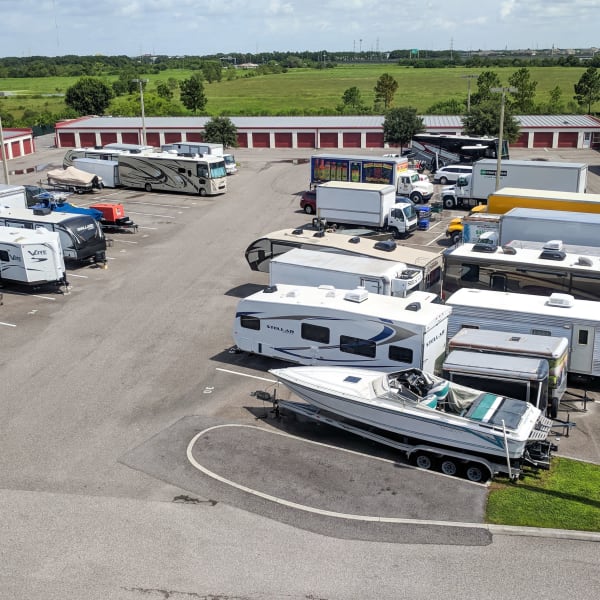 RVs, boats, trucks, and trailers parked at StorQuest Self Storage in Tampa, Florida