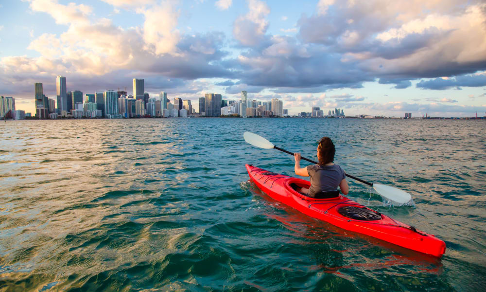 Kayaking toward Miami skyline for StorQuest Self Storage's partnership with Miami Waterkeeper