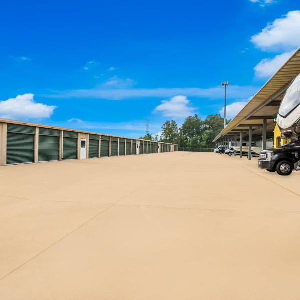 Outdoor parking spaces for RVs, trucks, and trailers at StorQuest Self Storage in Spring, Texas